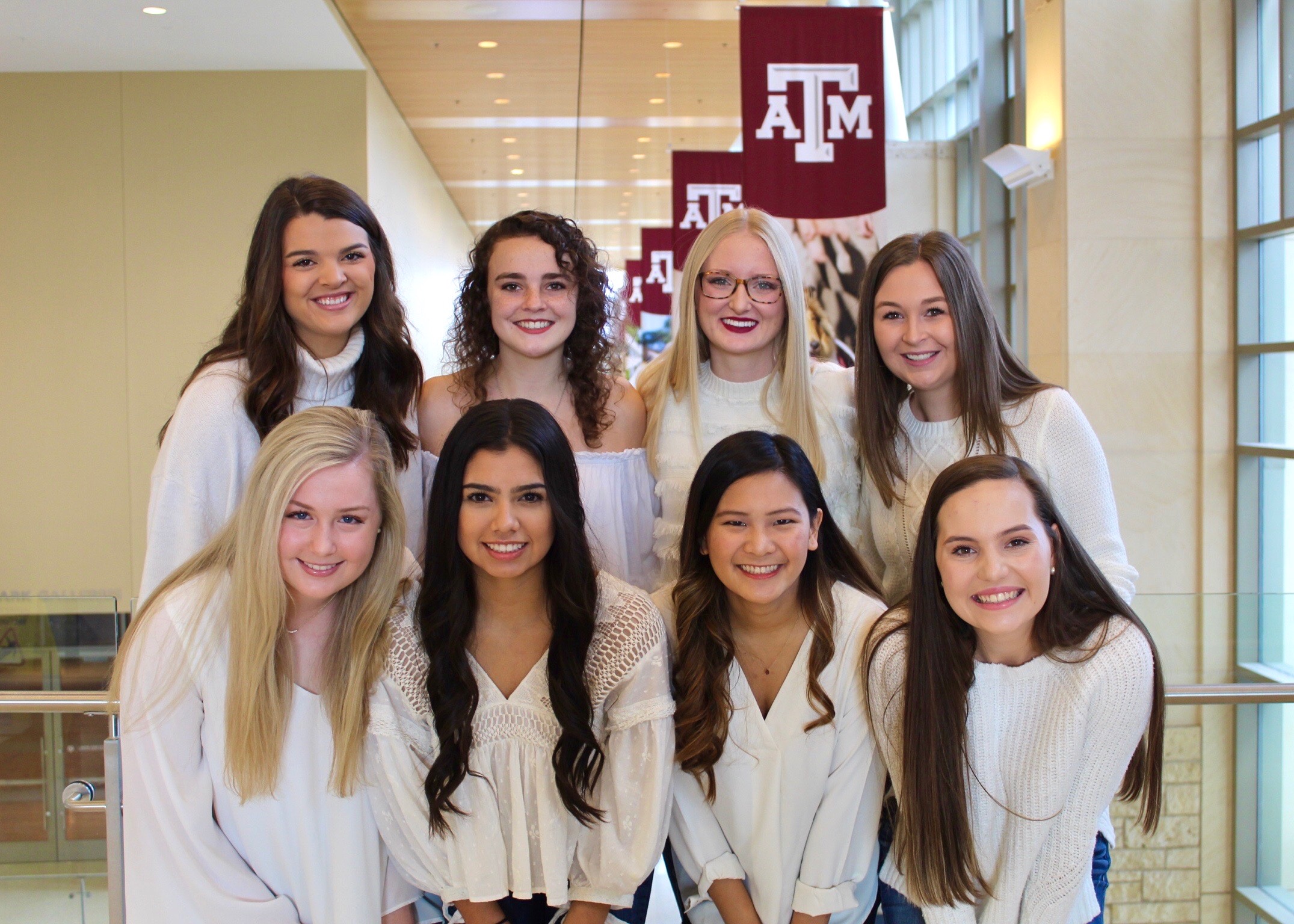 Eight CPC members smiling and posing together in two rows inside the MSC