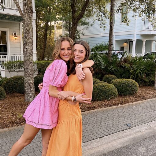 Two CPC members smiling and hugging each other outside